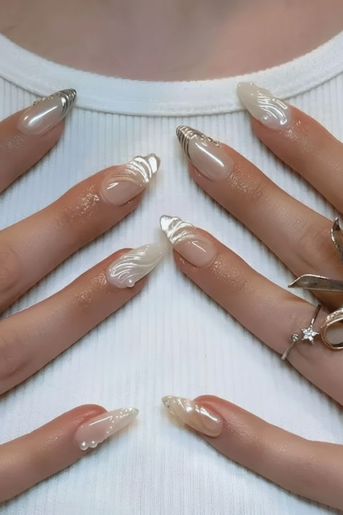 π
Channel Your Inner Goddess With This Opulent Nail Trend 6 Iridescent mermaid chrome nails decorated with delicate gold wire and tiny pearl embellishments. Opulent aquatic nail art design.