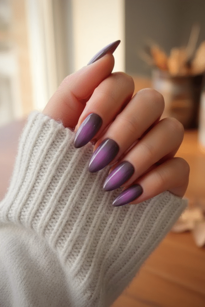 Aura nails in diffused plum, espresso, and olive tones with soft glow gradient effect
