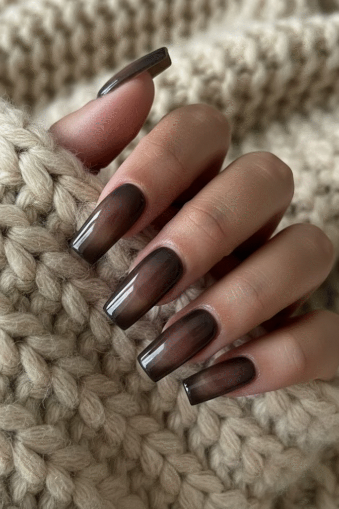 Aura nails in diffused plum, espresso, and olive tones with soft glow gradient effect
