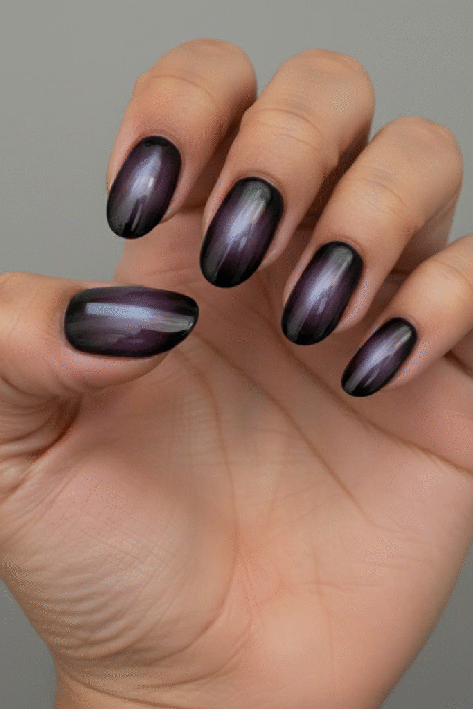 Aura nails in diffused plum, espresso, and olive tones with soft glow gradient effect
