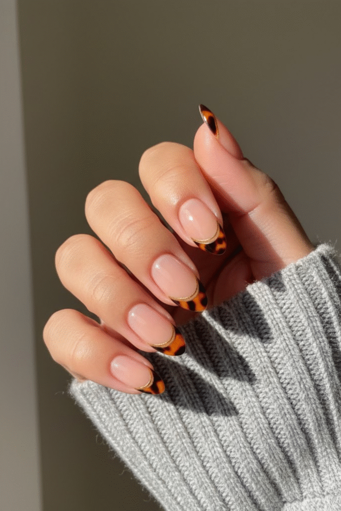 Tortoiseshell nails in amber, caramel, and dark espresso tones with glossy finish
