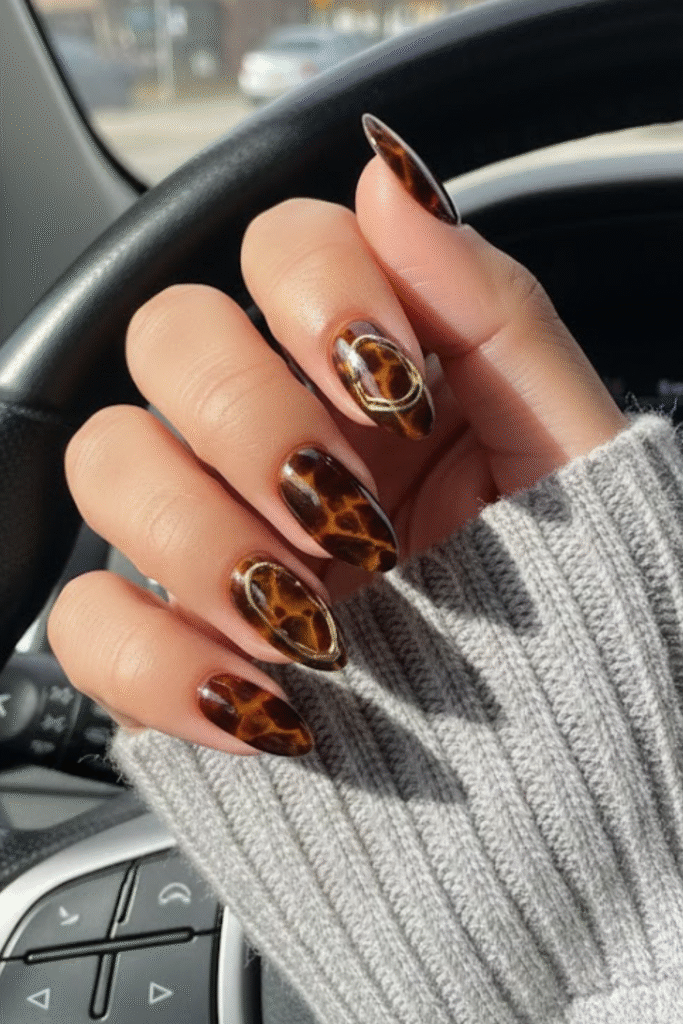 Tortoiseshell nails in amber, caramel, and dark espresso tones with glossy finish
