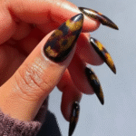 This abstract pattern of warm browns and amber is a fall staple. You can wear it as a full set or use it for accent nails, French tips, or a chic combination with a block of solid brown color.