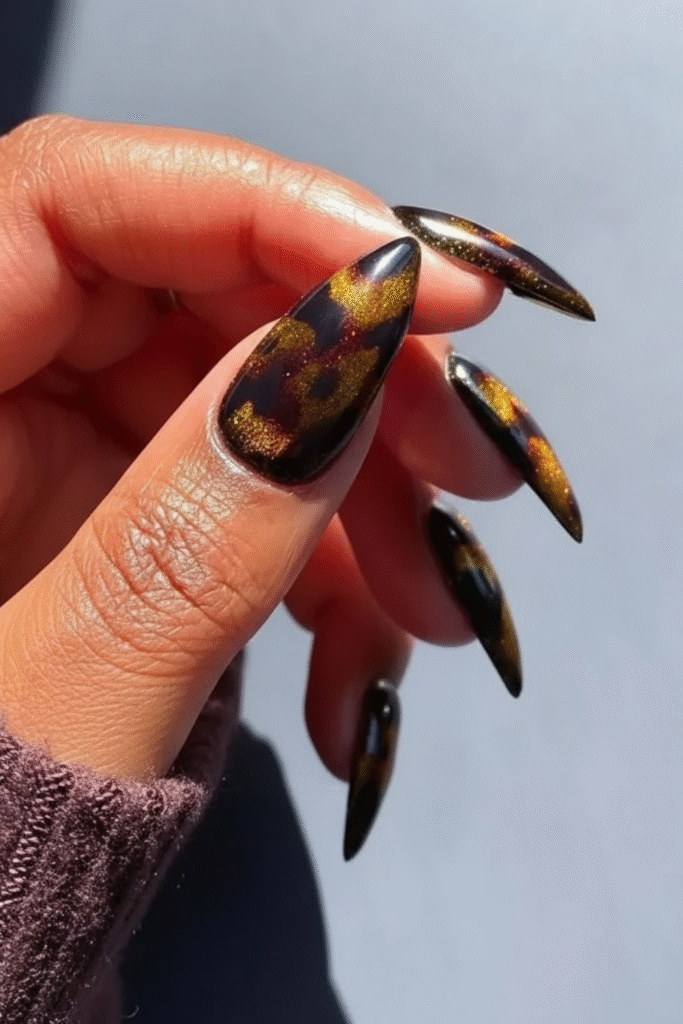 Tortoiseshell nails in amber, caramel, and dark espresso tones with glossy finish
