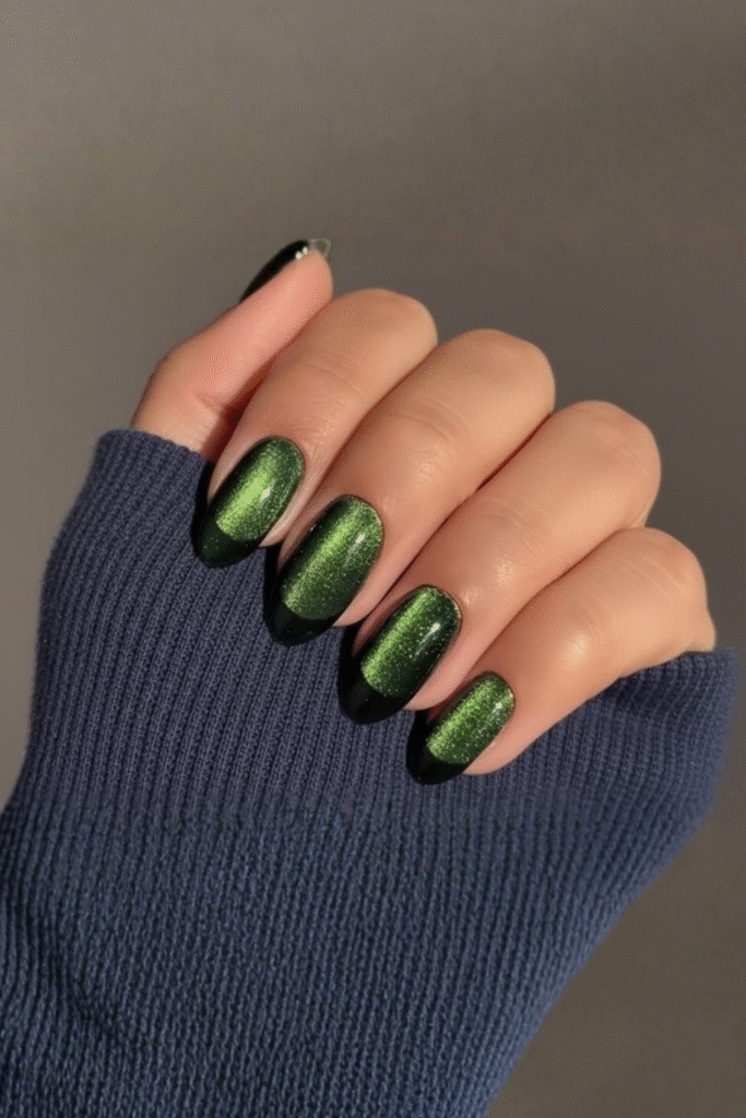 Velvet-effect magnetic nails in deep emerald and plum with soft shimmer finish